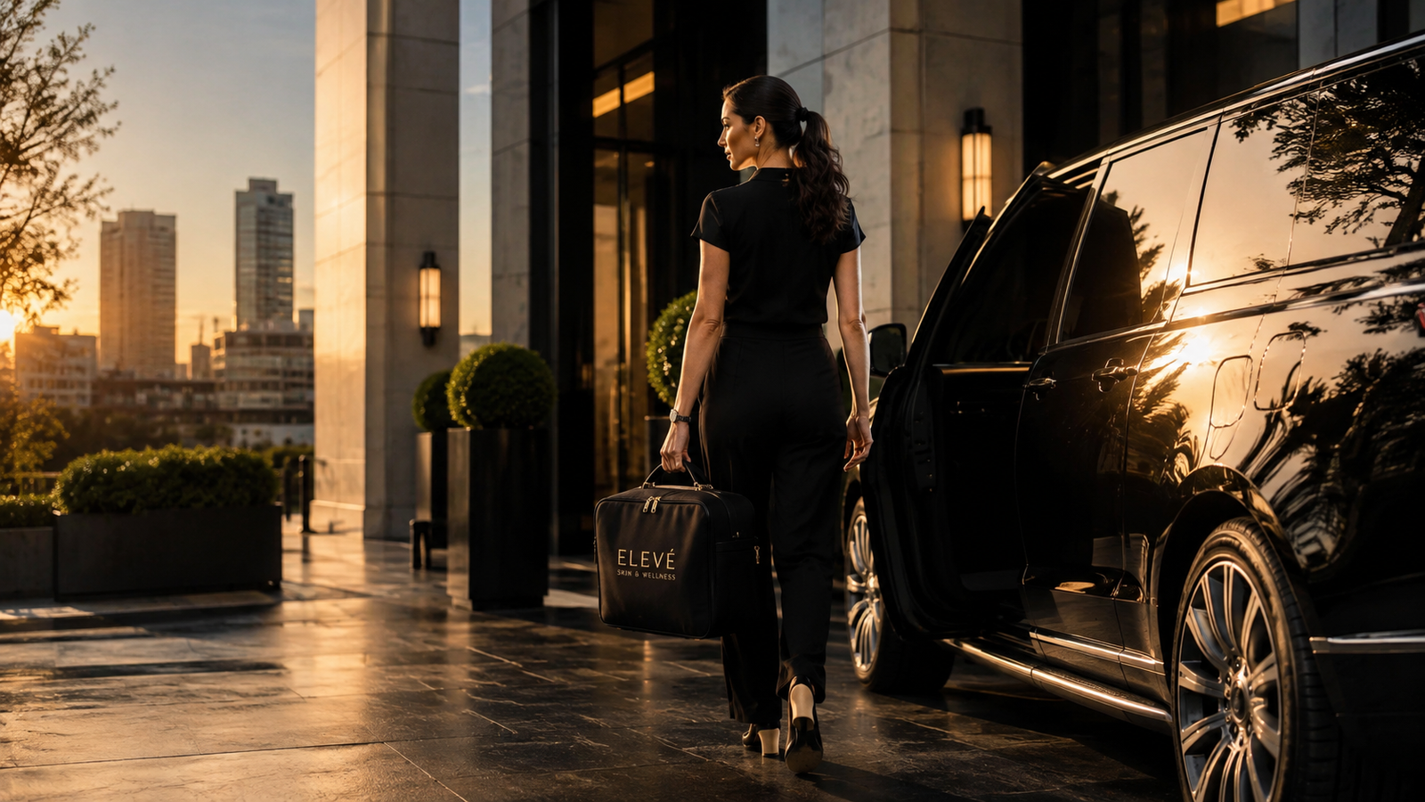 Elevé concierge nurse arriving with treatment bag beside a luxury SUV